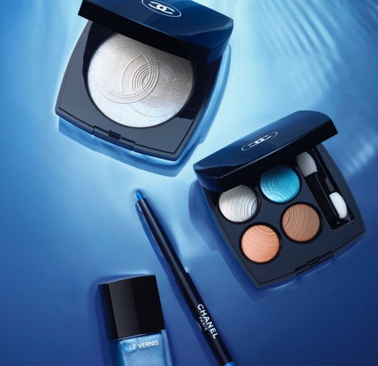 Chanel Makeup Products on a Blue Background